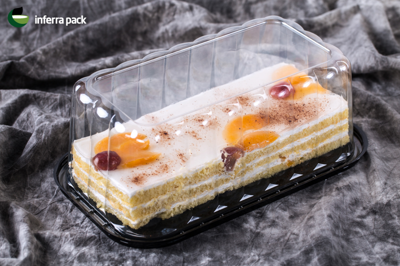 Rectangular cake containers with clear dome lid and black base.