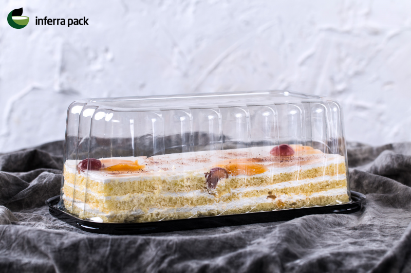 Rectangular cake containers with black base and clear lid.